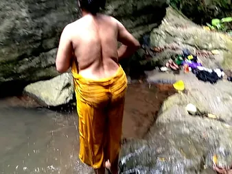 Ashok together with Surwana Kumari far flexuosities pissing in public while bathing in a pond in the mountains